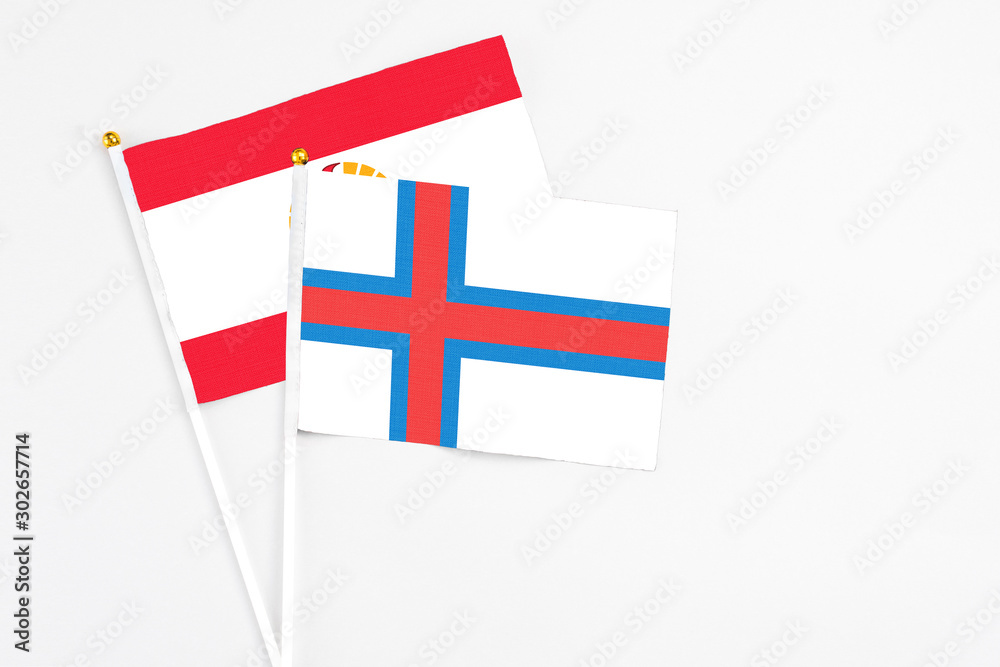 Faroe Islands and French Polynesia stick flags on white background. High quality fabric, miniature national flag. Peaceful global concept.White floor for copy space. Faroe Islands and French Polynesia stick flags on white background. High quality fabric, miniature national flag. Peaceful global concept.White floor for copy space.