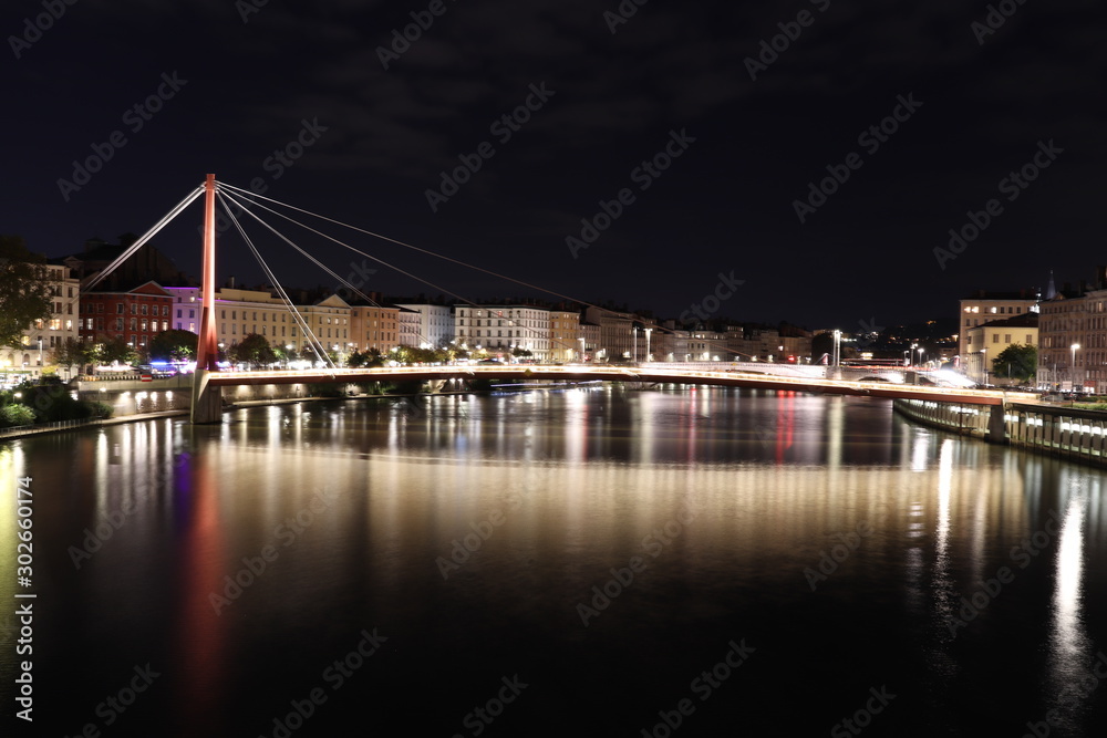 Obraz premium La passerelle du palais de justice sur la rivière Saône dans la ville de Lyon - Vue de nuit - Département du Rhône - France 