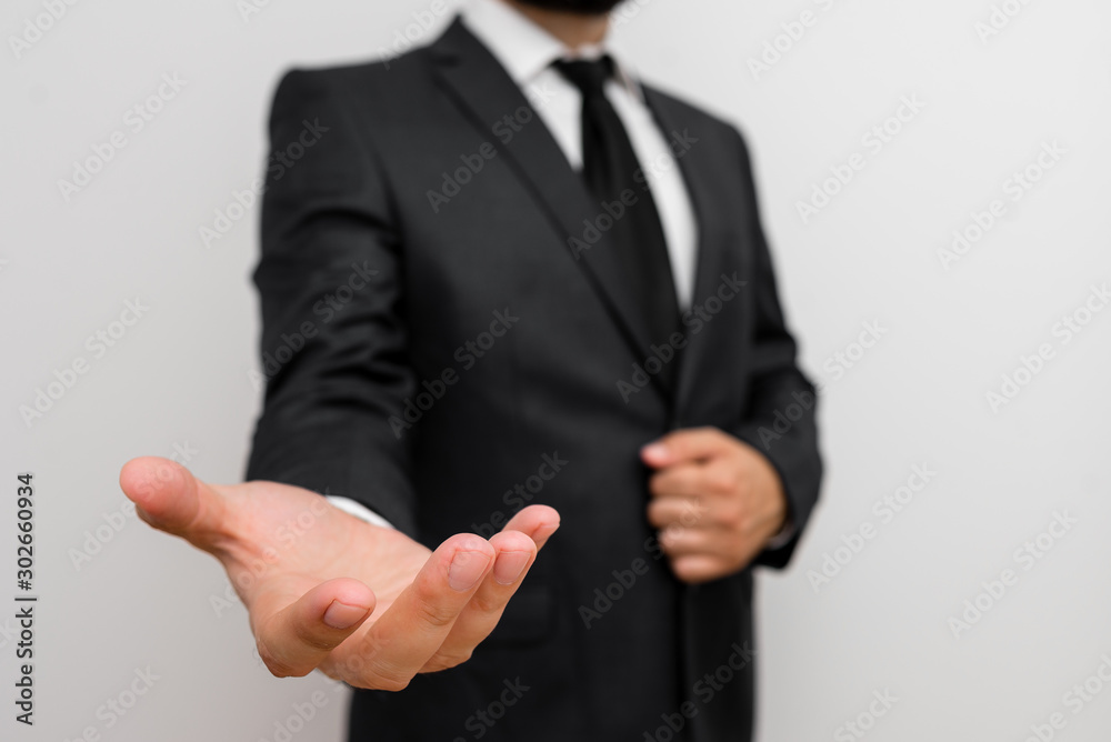 Male human with beard wear formal working suit clothes raising one hand up Male human with beard wear formal working suit clothes raising one hand up