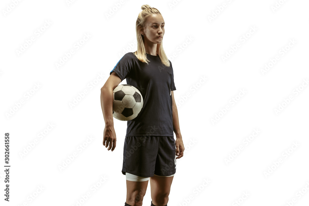 Young female soccer or football player with long hair in sportwear and boots training on white background. Concept of healthy lifestyle, professional sport, motion, movement. Stands with ball Young female soccer or football player with long hair in sportwear and boots training on white background. Concept of healthy lifestyle, professional sport, motion, movement. Stands with ball