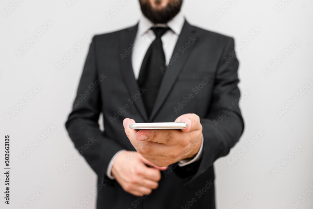 Male human wear formal work suit hold smart hi tech smartphone use one hand Male human wear formal work suit hold smart hi tech smartphone use one hand