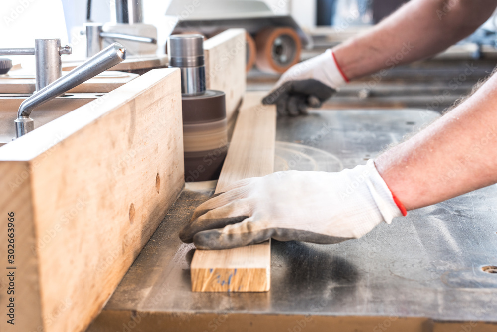 polishing up wooden board on a carpentry machin 