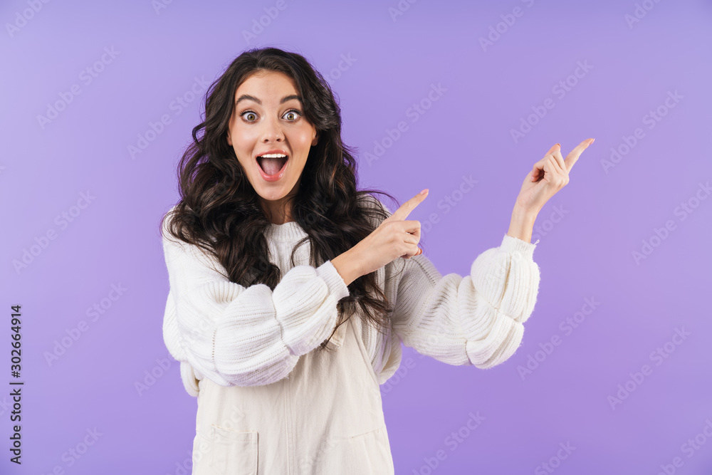 Emotional young brunette woman pointing aside. Emotional young brunette woman pointing aside.
