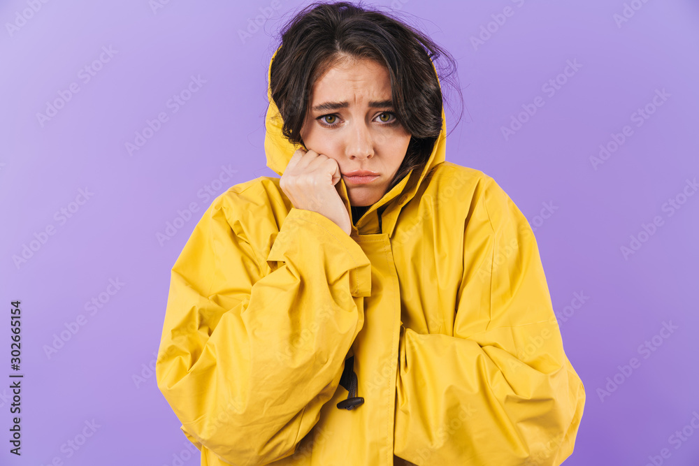Frozen cute brunette woman in yellow raincoat Frozen cute brunette woman in yellow raincoat