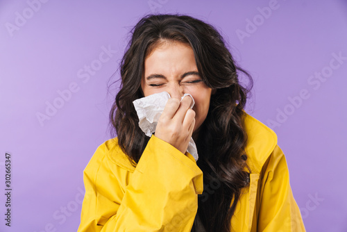 Sick woman isolated over purple wall background