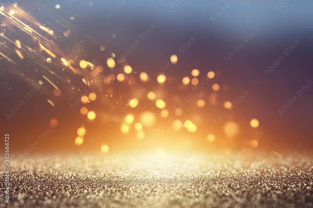 background of abstract glitter lights. gold and black. de focused