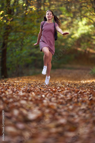 Fototapeta Naklejka Na Ścianę i Meble -  Schoolgirl walking in the forest