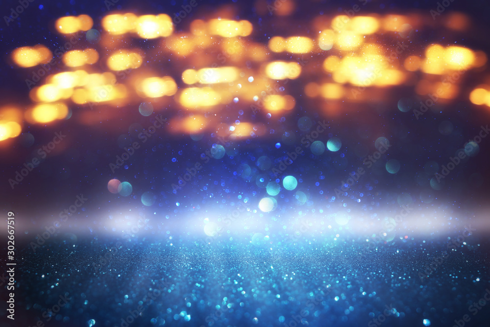 Naklejka premium abstract glitter black, blue and gold lights background. de-focused