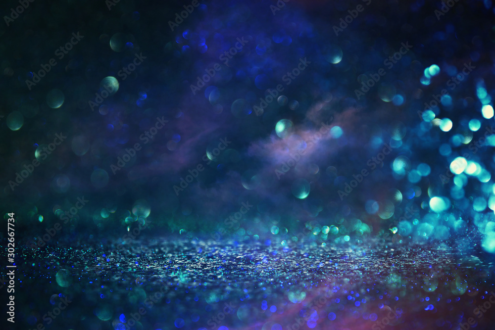 abstract glitter black and blue lights background. de-focused