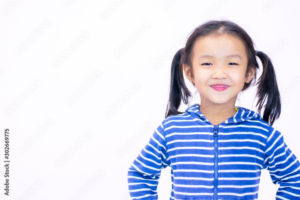 A little girl with a smiling face, aged three and a half wearing a blue sweate A little girl with a smiling face, aged three and a half wearing a blue sweate