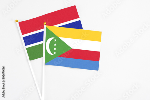Free Download Comoros and Georgia stick flags on white background. High quality fabric, miniature national flag. Peaceful global concept.White floor for copy space. - GFXLoad