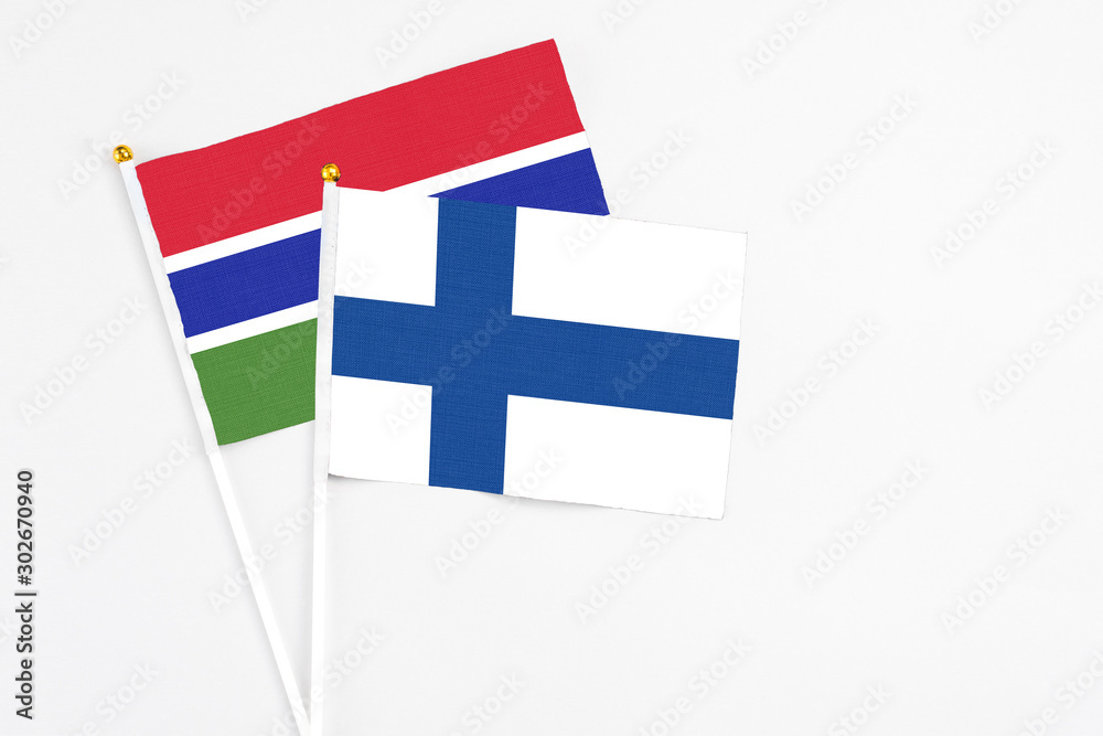 Finland and Georgia stick flags on white background. High quality fabric, miniature national flag. Peaceful global concept.White floor for copy space.