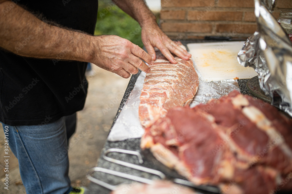 man preparing pork ribs