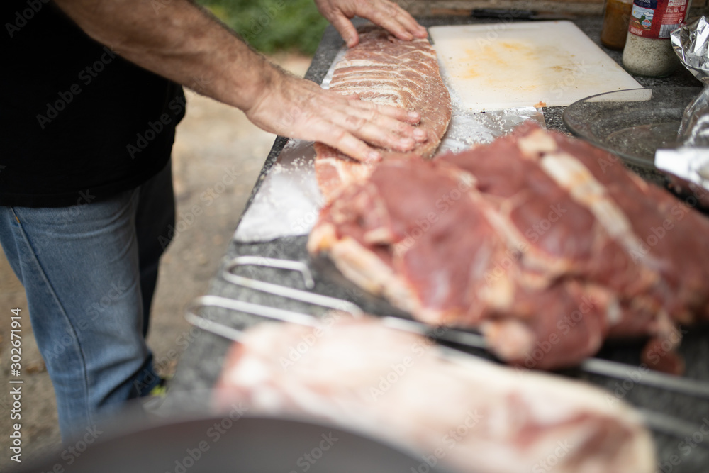man preparing pork ribs