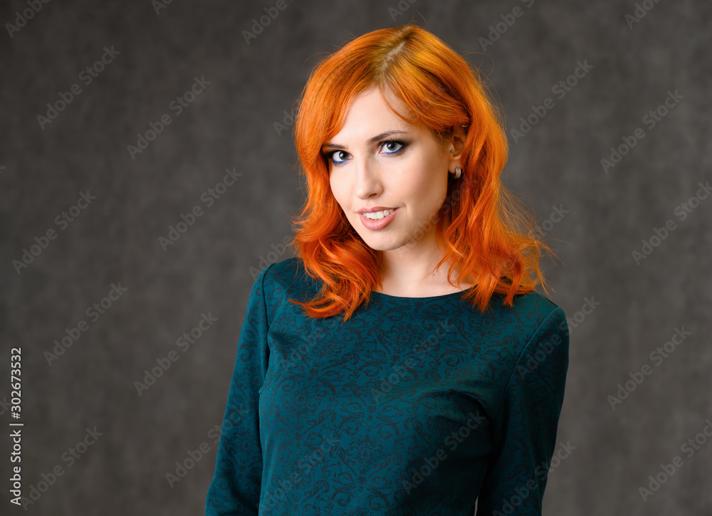 Close-up Portrait of a red-haired pretty girl with excellent makeup and bright curly hair on a gray background. Beauty concept, sample of beautiful hairstyle and makeup with cosmetics. Close-up Portrait of a red-haired pretty girl with excellent makeup and bright curly hair on a gray background. Beauty concept, sample of beautiful hairstyle and makeup with cosmetics.
