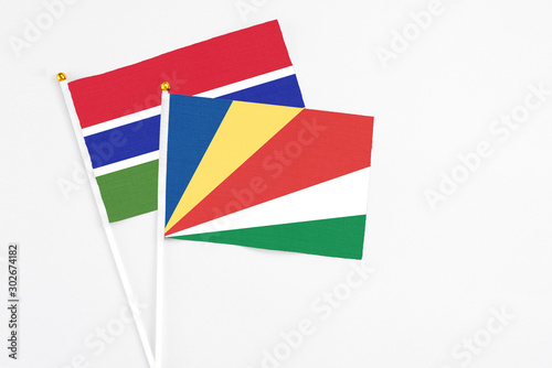 Seychelles and Georgia stick flags on white background. High quality fabric  miniature national flag. Peaceful global concept.White floor for copy space.