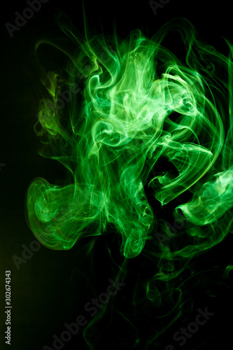 Green smoke motion on black background.