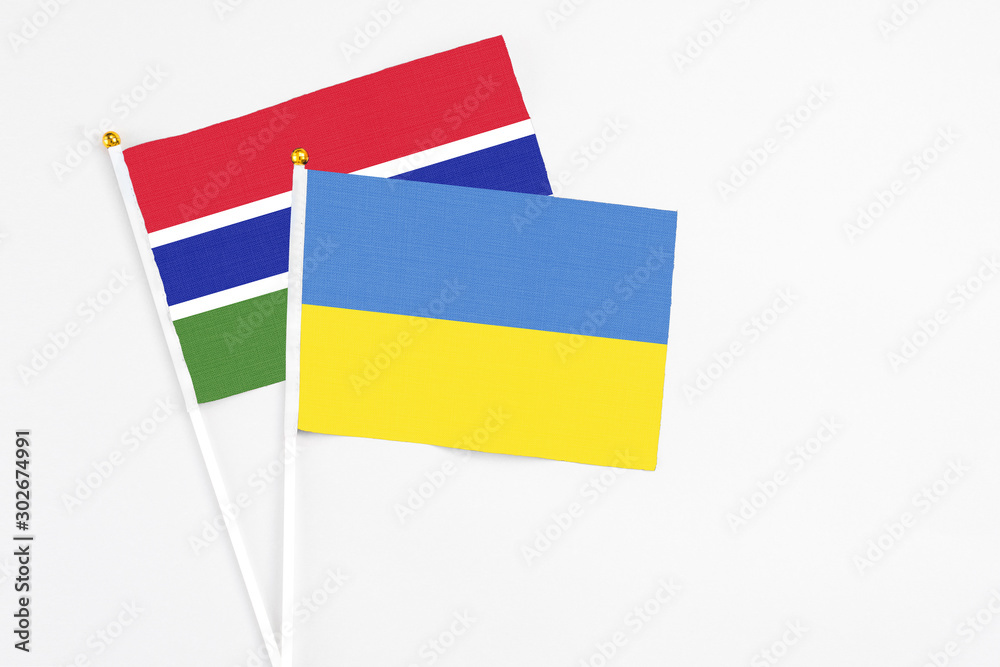 Ukraine and Georgia stick flags on white background. High quality fabric, miniature national flag. Peaceful global concept.White floor for copy space.