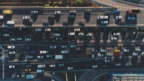 Aerial drone flight top view pan shot left to right of freeway busy traffic jam highway. Aerial view of the vehicular intersection, traffic at peak hour