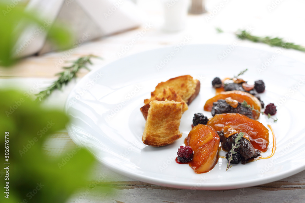 Fried chicken liver with raspberry and blackberry fruit served with caramelized apple and croutons