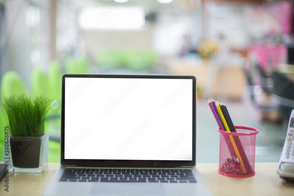 Computer laptop with white blank screen isolated on work table in office. Computer laptop with white blank screen isolated on work table in office.