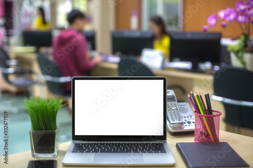 Computer laptop with white blank screen isolated  on work table in office.