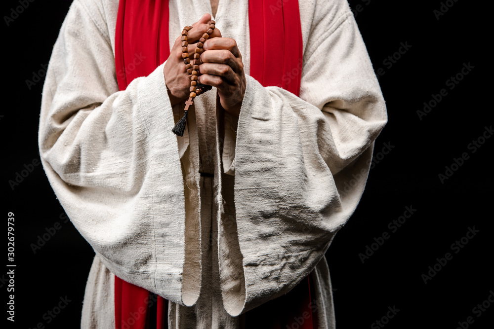 cropped view of religious man holding rosary beads isolated on black