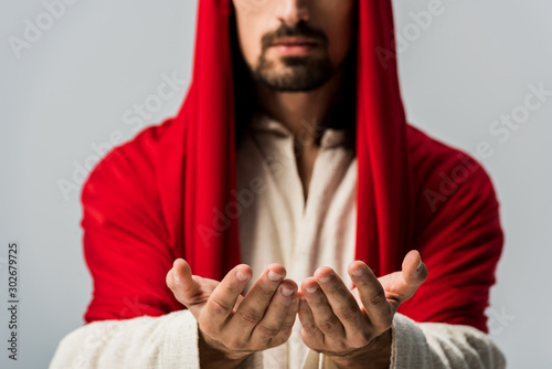 selective focus of bearded man with cupped hands isolated on grey