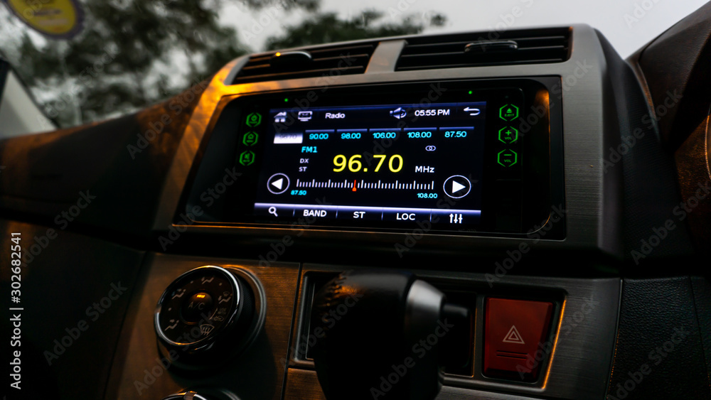 The close up view of the smart multimedia touchscreen radio panel in the car.