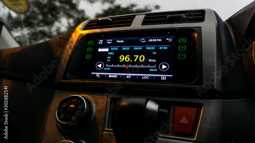 The close up view of the smart multimedia touchscreen radio panel in the car.
