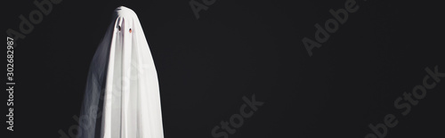 panoramic shot of ghost in white bedsheet isolated on black with copy space