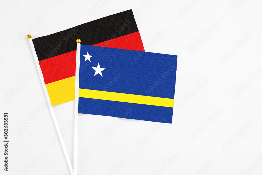 Curacao and Germany stick flags on white background. High quality fabric, miniature national flag. Peaceful global concept.White floor for copy space. Curacao and Germany stick flags on white background. High quality fabric, miniature national flag. Peaceful global concept.White floor for copy space.