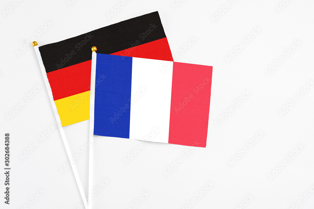 France and Germany stick flags on white background. High quality fabric, miniature national flag. Peaceful global concept.White floor for copy space. France and Germany stick flags on white background. High quality fabric, miniature national flag. Peaceful global concept.White floor for copy space.
