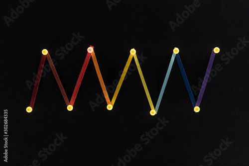 top view of multicolored abstract connected lines with pins isolated on black, connection and communication concept