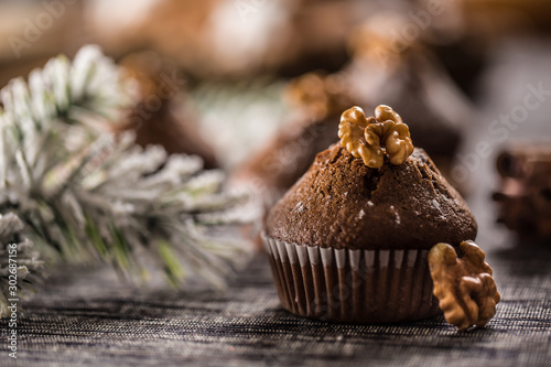 Christmas chocolate delicious muffins sprinklad with sugar powder and wallnut on top photo