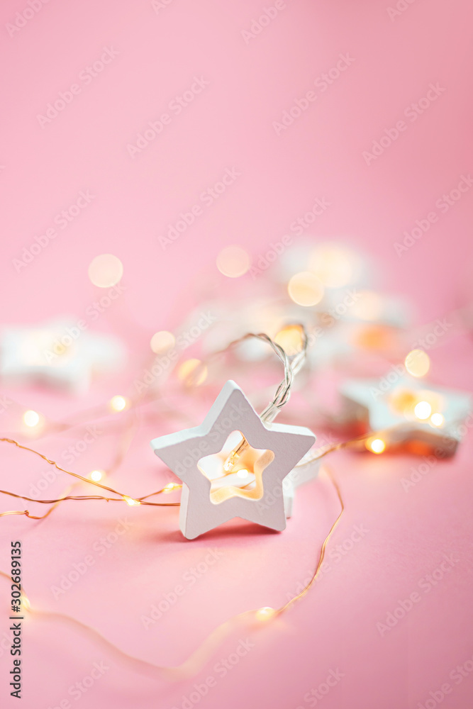 Merry Christmas and Happy Holidays  banner, greeting card. Wooden stars on a yellow christmas light bokeh background with copy space.Winter holiday theme. Wallpaper.