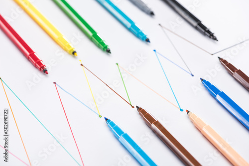 colorful felt-tip pens on white background with connected drawn lines, connection and communication concept