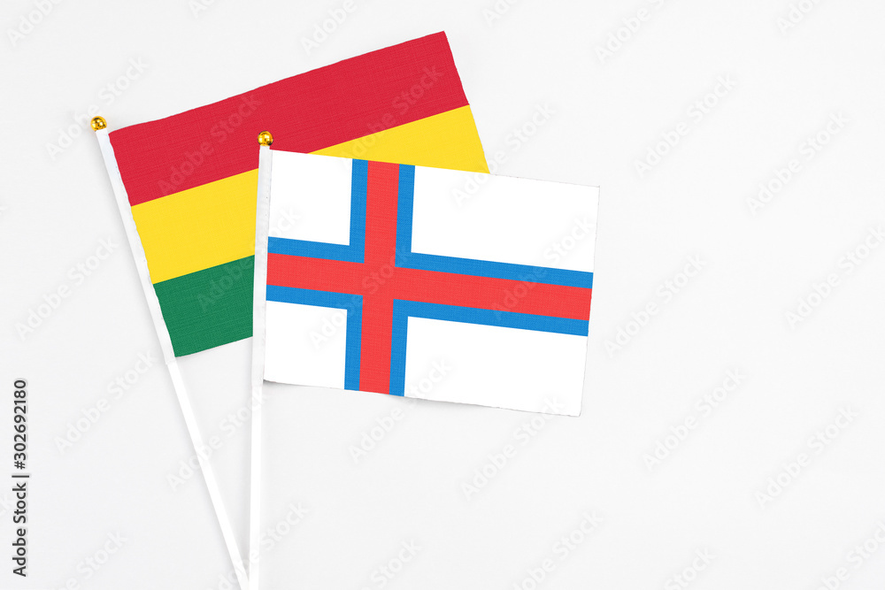 Faroe Islands and Ghana stick flags on white background. High quality fabric, miniature national flag. Peaceful global concept.White floor for copy space. Faroe Islands and Ghana stick flags on white background. High quality fabric, miniature national flag. Peaceful global concept.White floor for copy space.