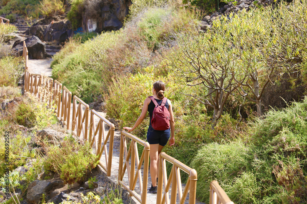 Tourist girl backpacker walking on the tourist path in Tenerife, Canary Islands, Spain. Tourist girl backpacker walking on the tourist path in Tenerife, Canary Islands, Spain.