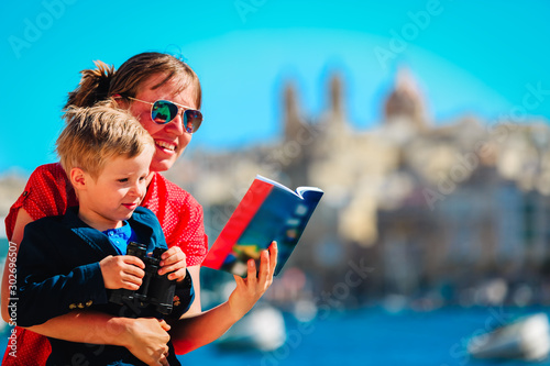 mother and son travel in Malta, Europe, family looking at travel guide book photo