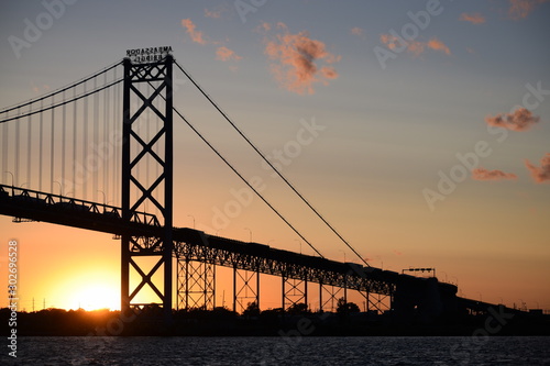 Ambassador Bridge between Detroit, Michigan and Windsor, Ontario. Sunset on the Detroit River with the silhouette of the bridge. Border crossing between the US and Canada photo