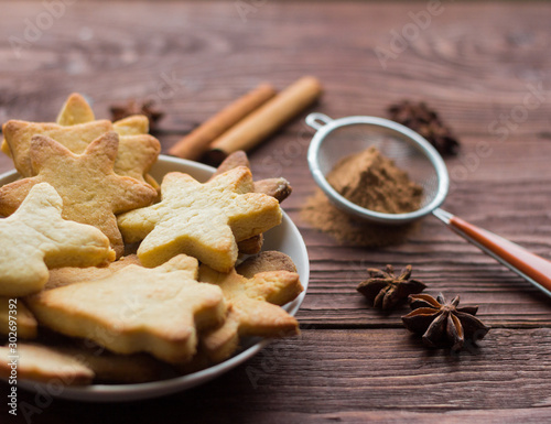 Fototapeta Naklejka Na Ścianę i Meble -  Homemade Christmas cookies and spices on wooden background