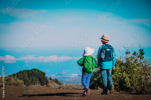 kids -little boy and girl travel in mountains, family hiking