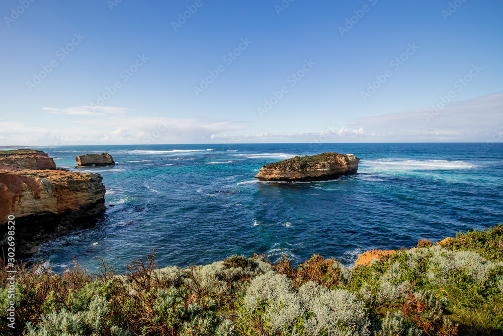 Bay of Martyrs. Tourist attraction on the Great Ocean Road. Rock formation in the ocean. Foreground with bushes. Australia landscape. Victoria, Australia
