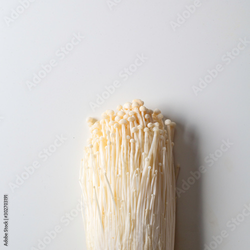 enoki mushrooms on white vibrant background