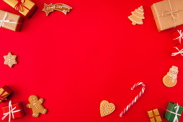 Invitation x-mas card idea. High angle view photo of baked newyear elements figures holiday composition with empty space in middle made isolated on bright red background