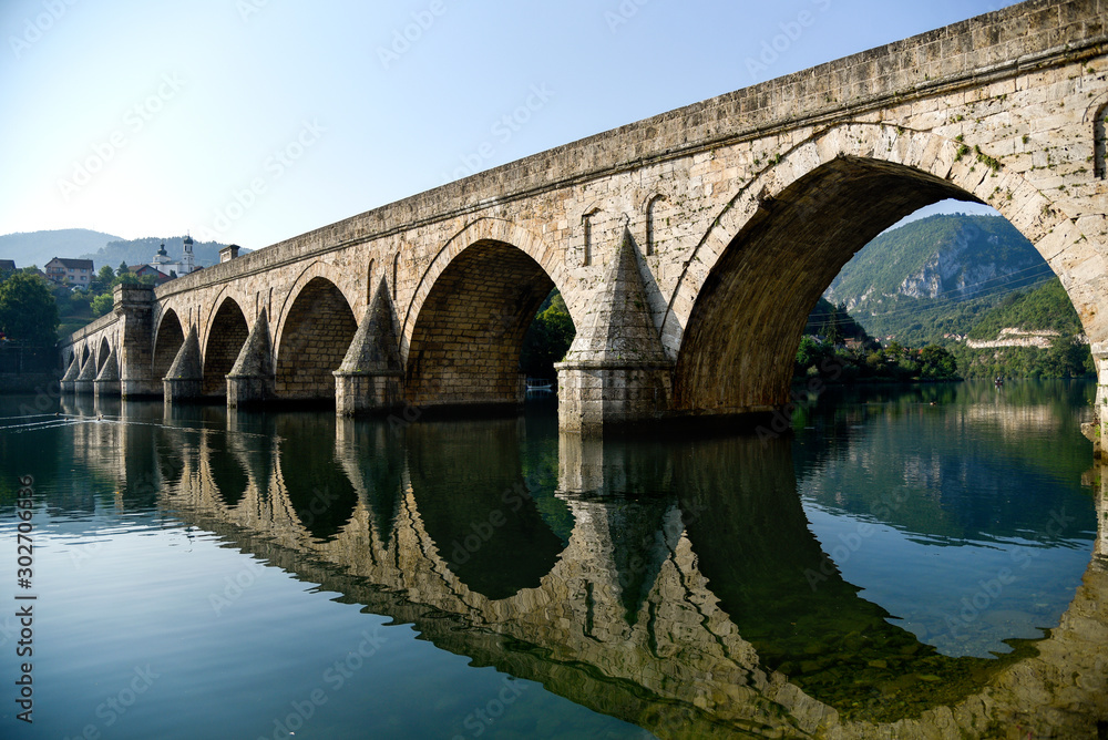 The Ottoman Mehmed Pasa Sokolovic Bridge in Visegrad, river reflection. Bosnia and Herzegovina.