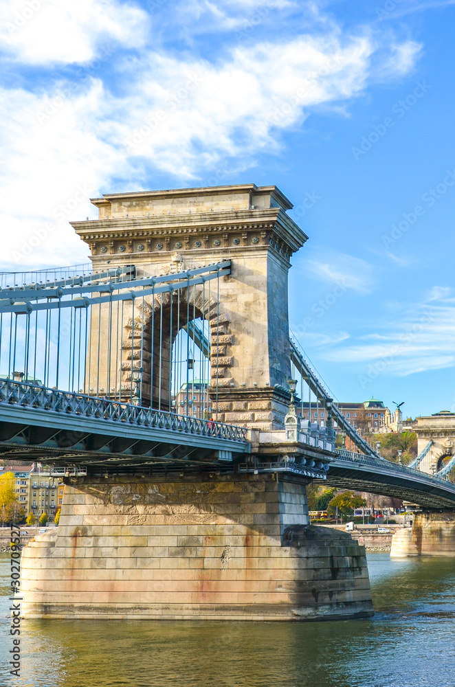 Obraz premium Amazing construction of the Szechenyi Chain Bridge, suspension bridge, over the Danube river in Budapest, Hungary. Tourist landmark in the Hungarian capital city. Historical architecture
