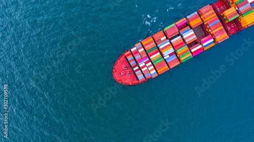 Container ship carrying container for business freight shipping import and export, Aerial view container ship arriving in commercial port. © Kalyakan