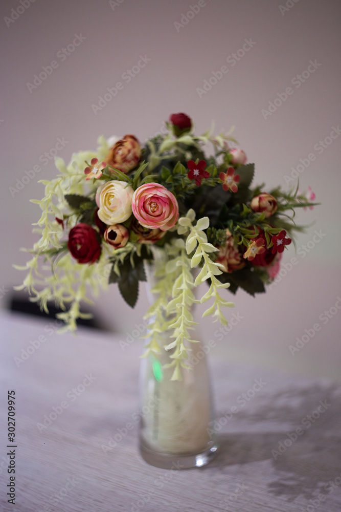 Fototapeta premium Bouquet flower in a white vase on a light background